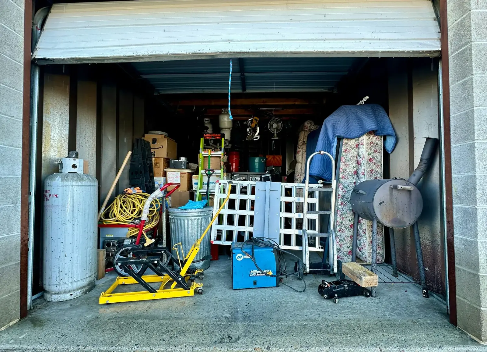 Open storage unit filled with household items and tools